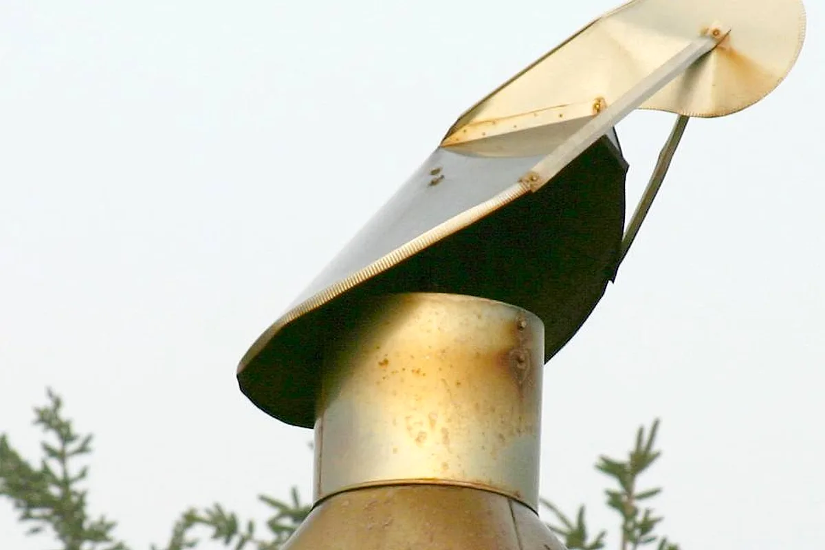 Metal rain cap fitted on top of a chimney flue